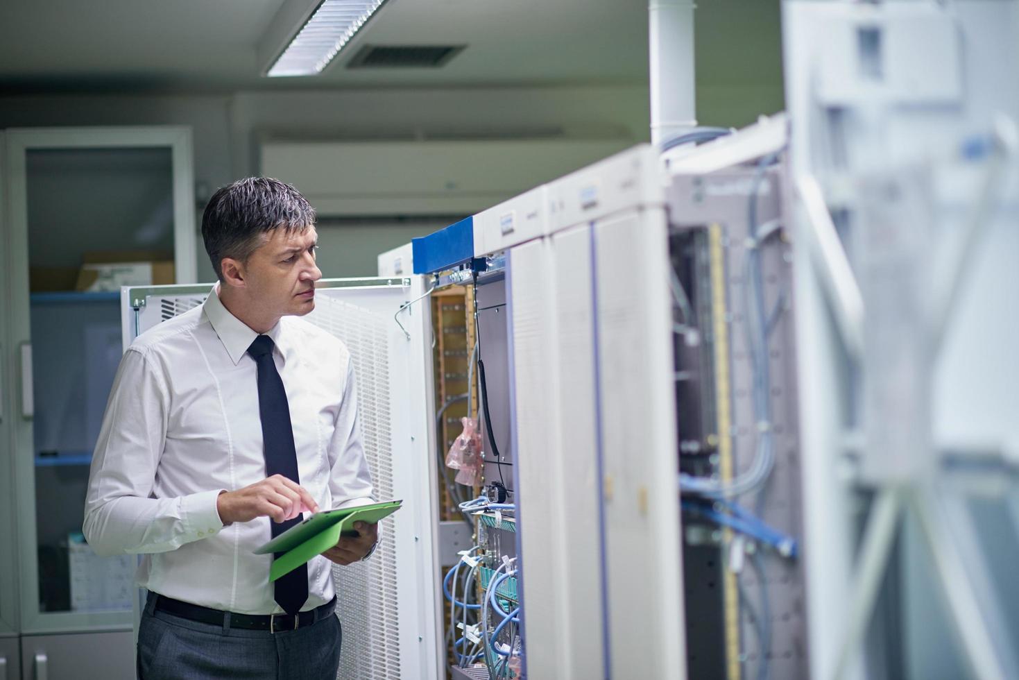 network engineer working in  server room photo