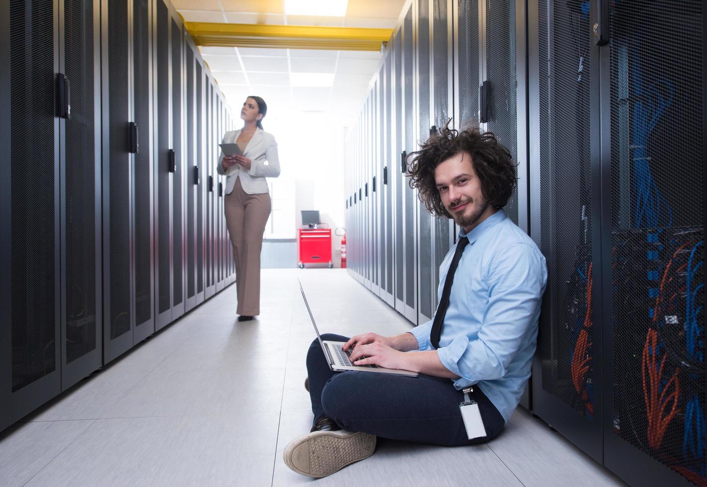 Team of young technicians working together on servers photo