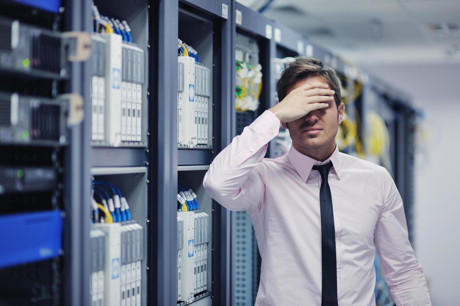 young it engeneer in datacenter server room photo