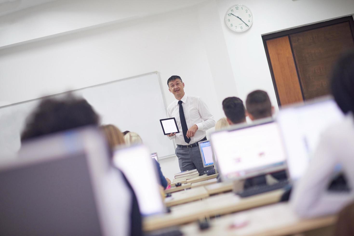 students with teacher  in computer lab classrom photo