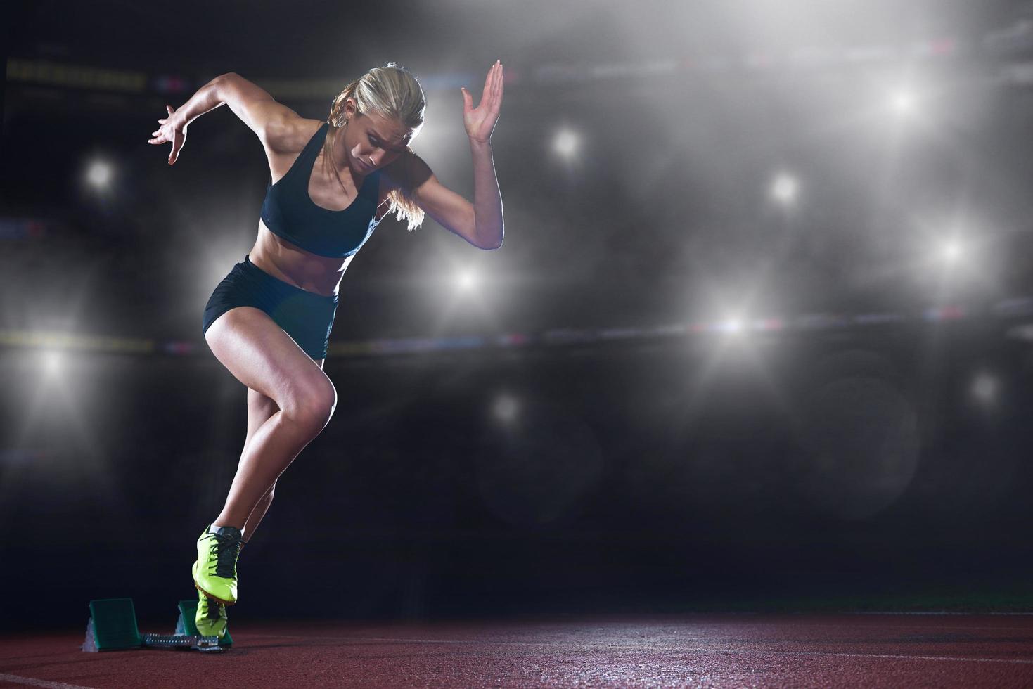 pixelated design of woman  sprinter leaving starting blocks photo