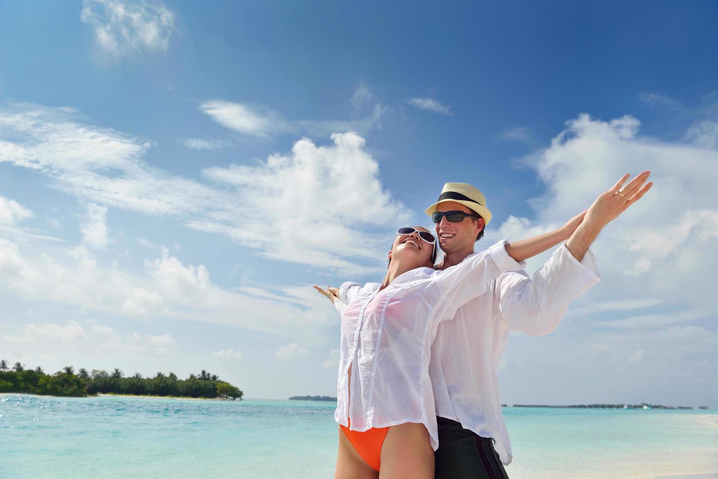 happy young couple have fun on beach photo