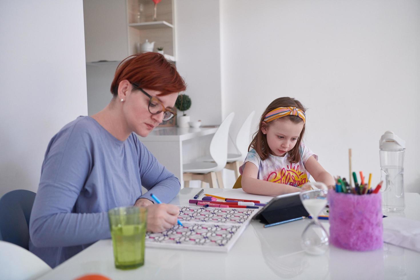 Mother and little daughter  playing together  drawing creative artwork photo