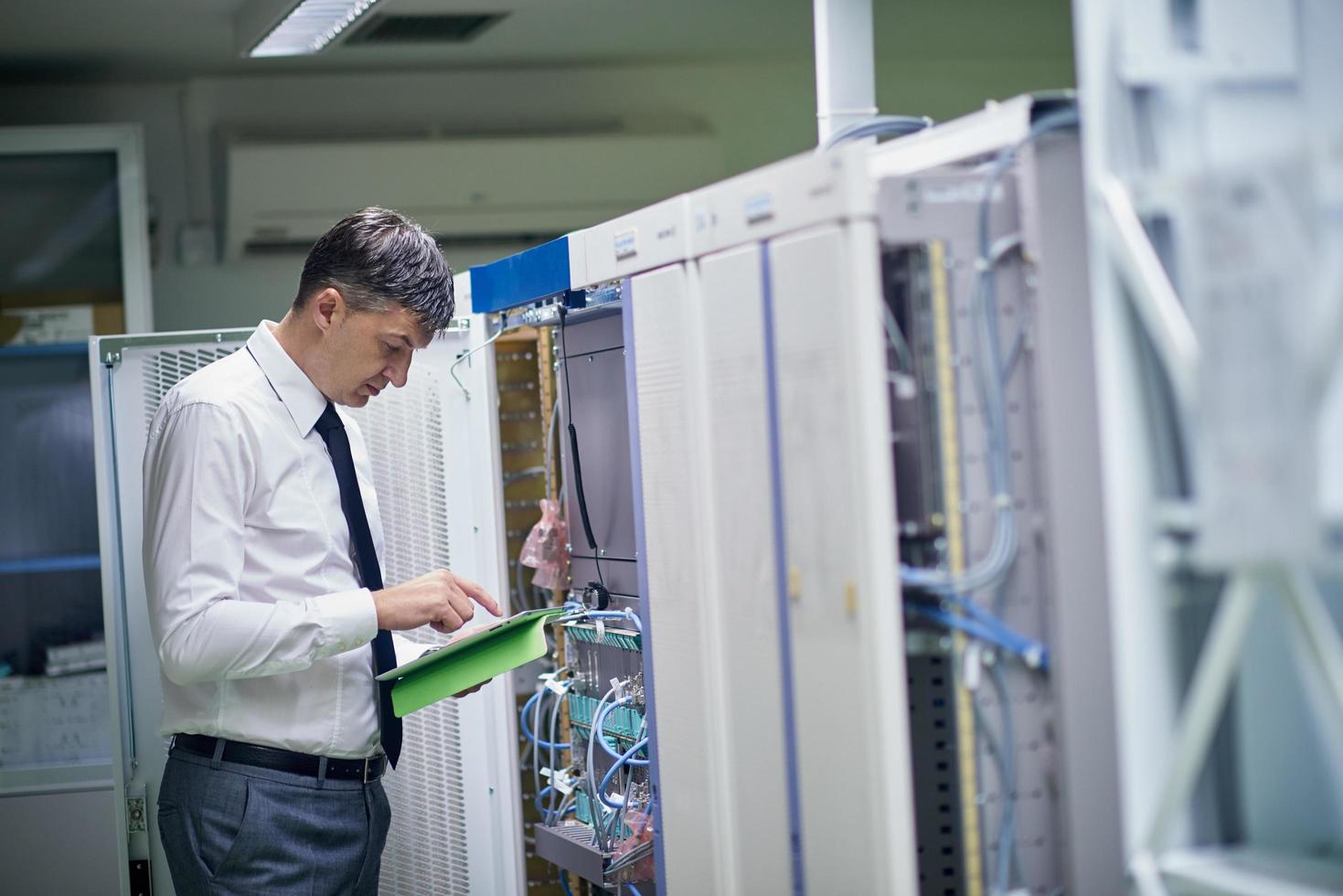 network engineer working in  server room photo