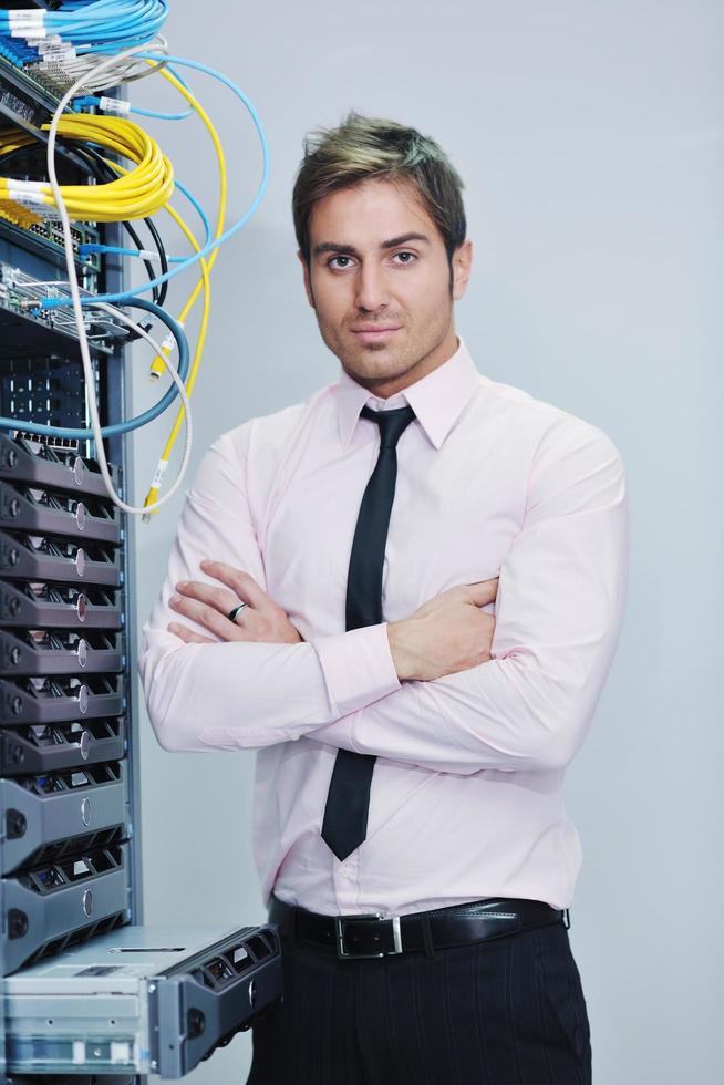 young it engineer in datacenter server room photo