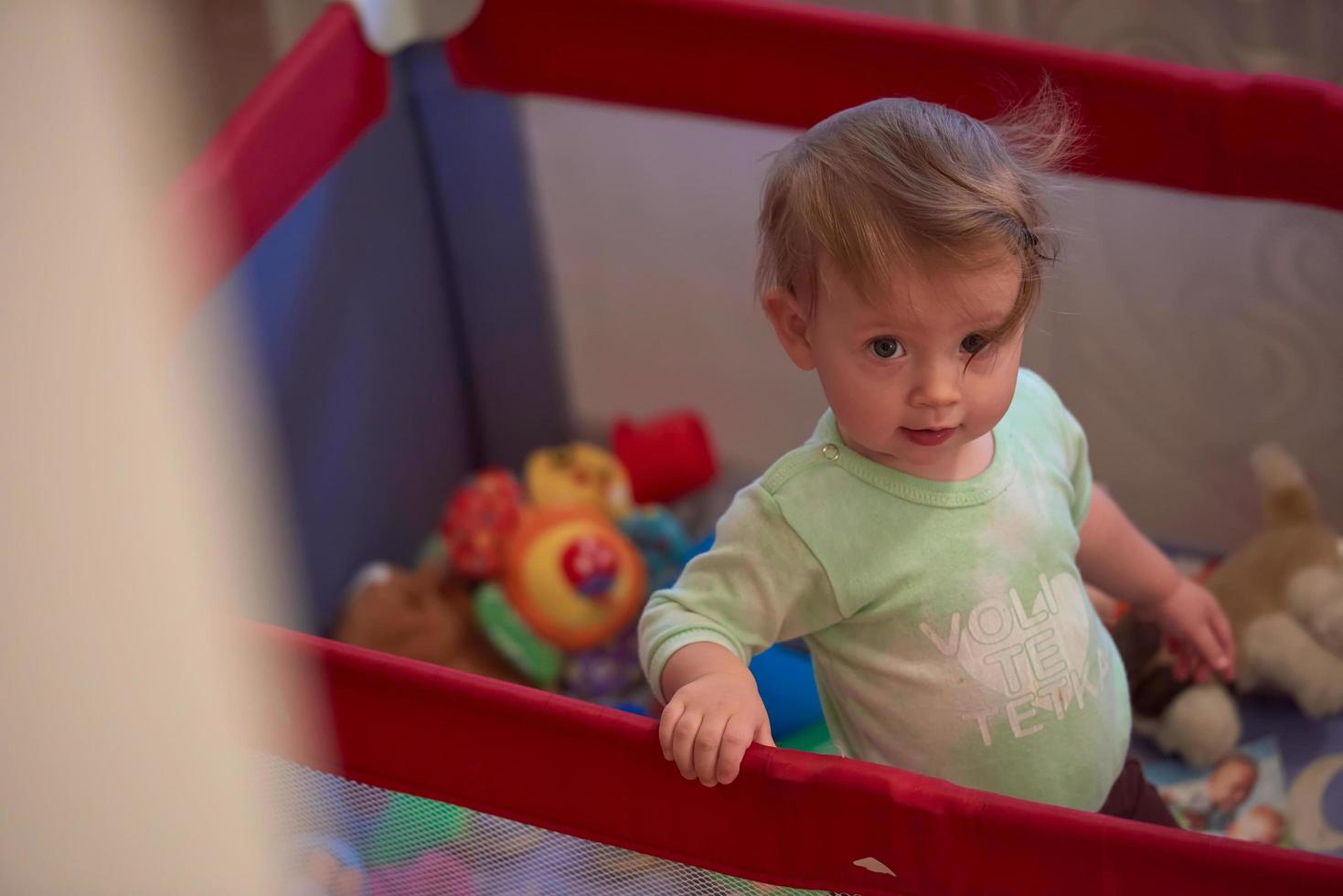 cute  little  baby playing in mobile  bed photo