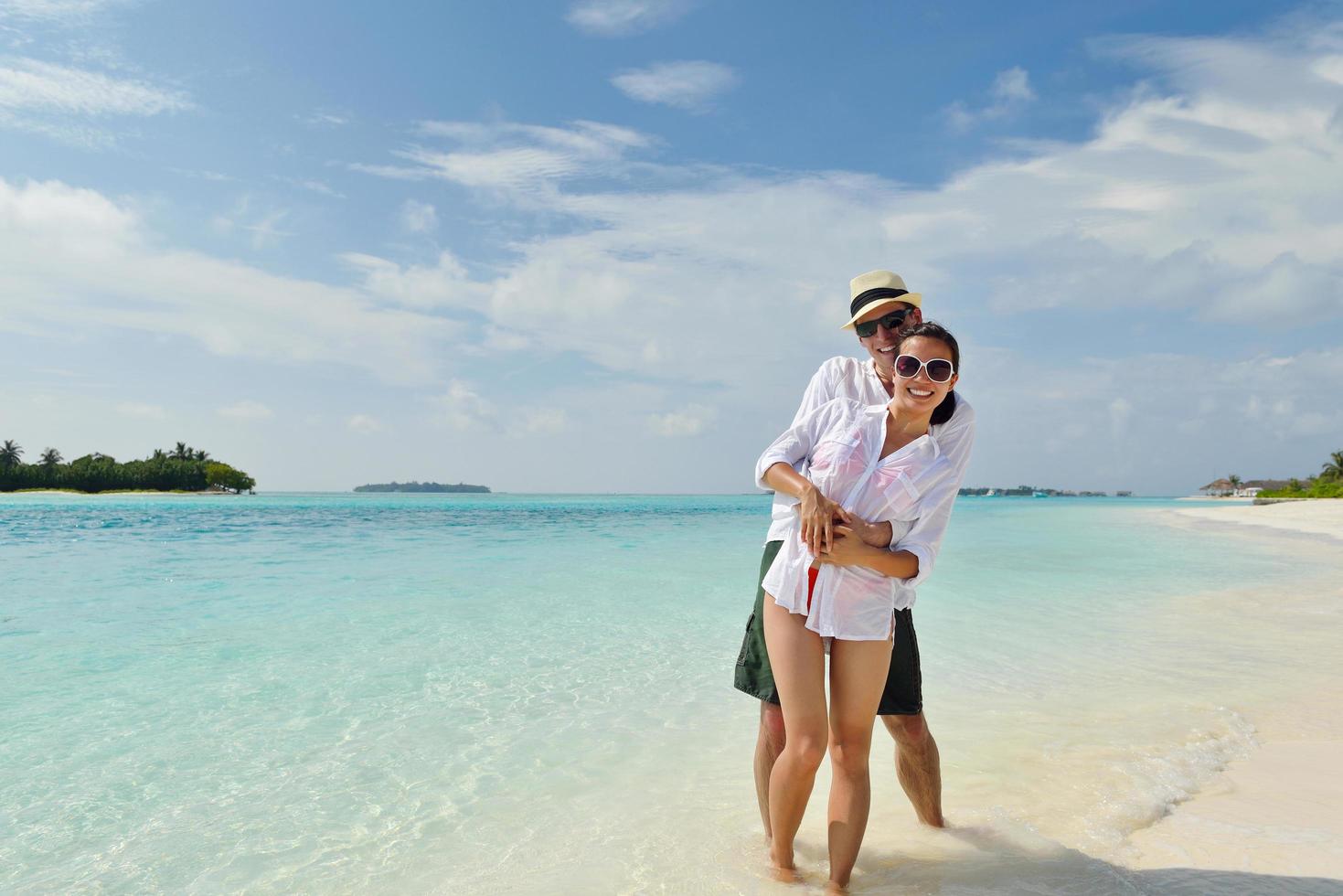 happy young couple have fun on beach photo