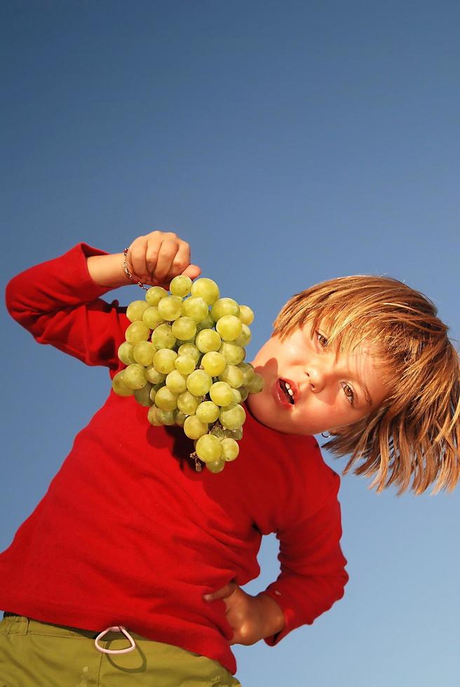 happy girl with grape outside photo