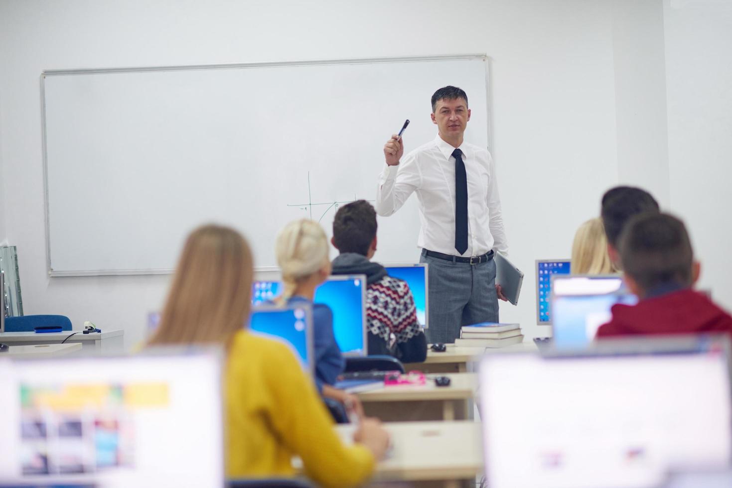 students with teacher  in computer lab classrom photo