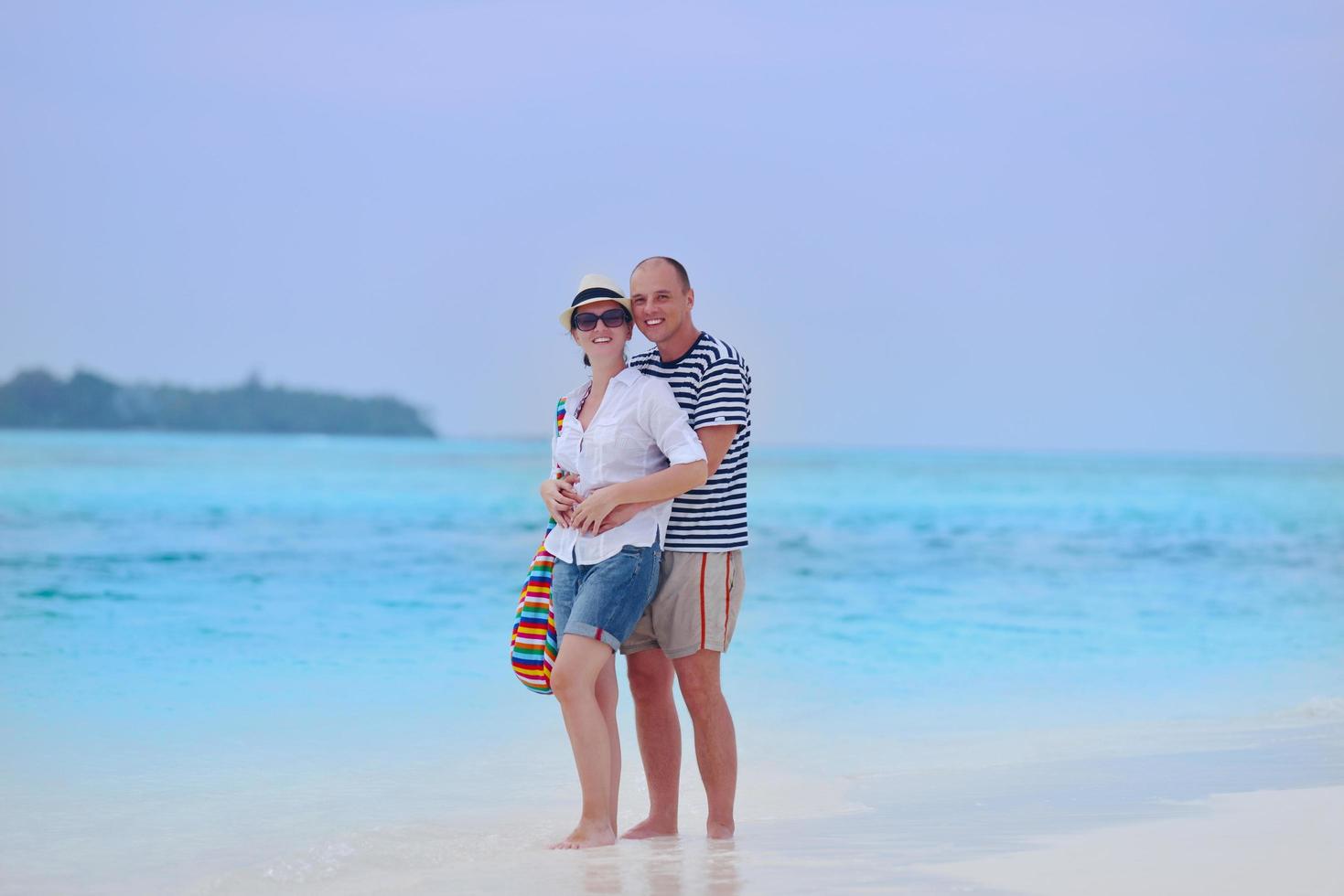 happy young couple have fun on beach photo