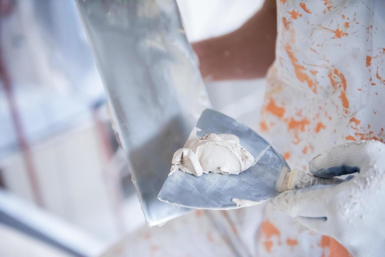 construction worker plastering on gypsum walls photo