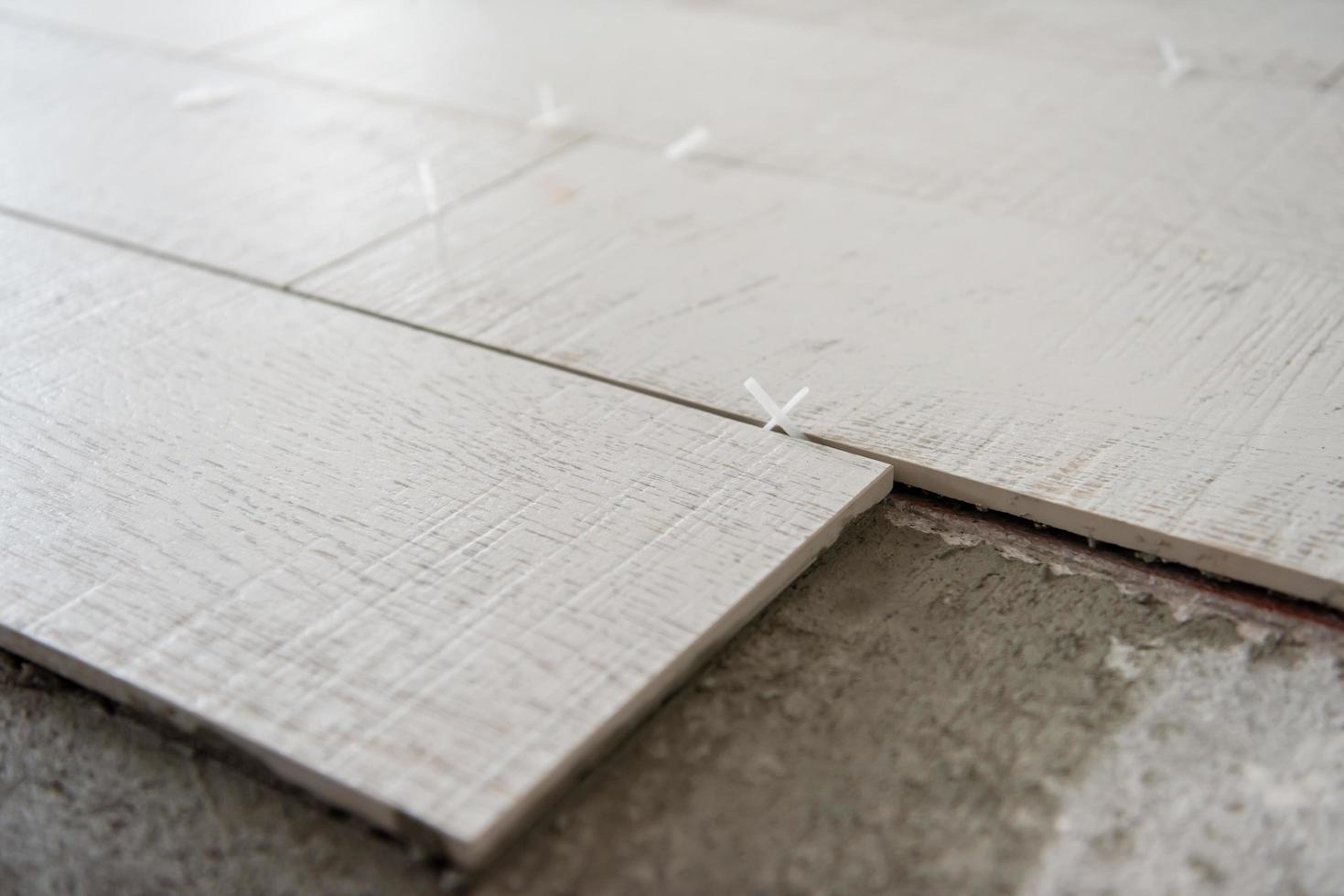 Ceramic wood effect tiles and tools for tiler on the floor photo