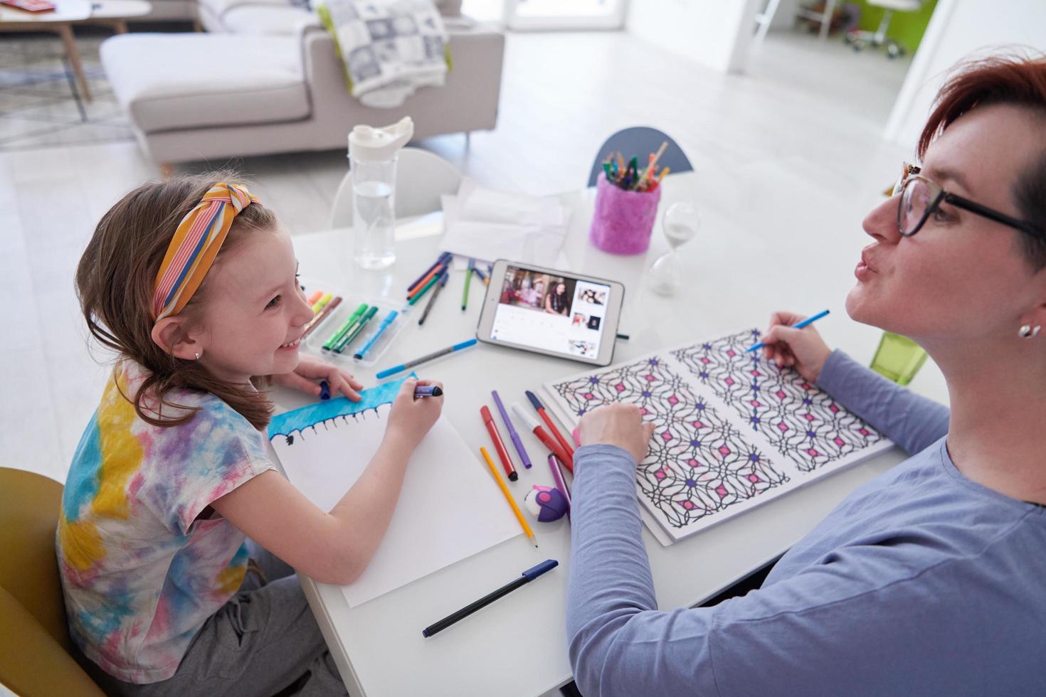Mother and little daughter  playing together  drawing creative artwork photo