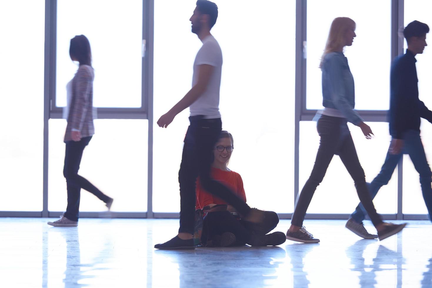 student girl standing with laptop, people group passing by photo