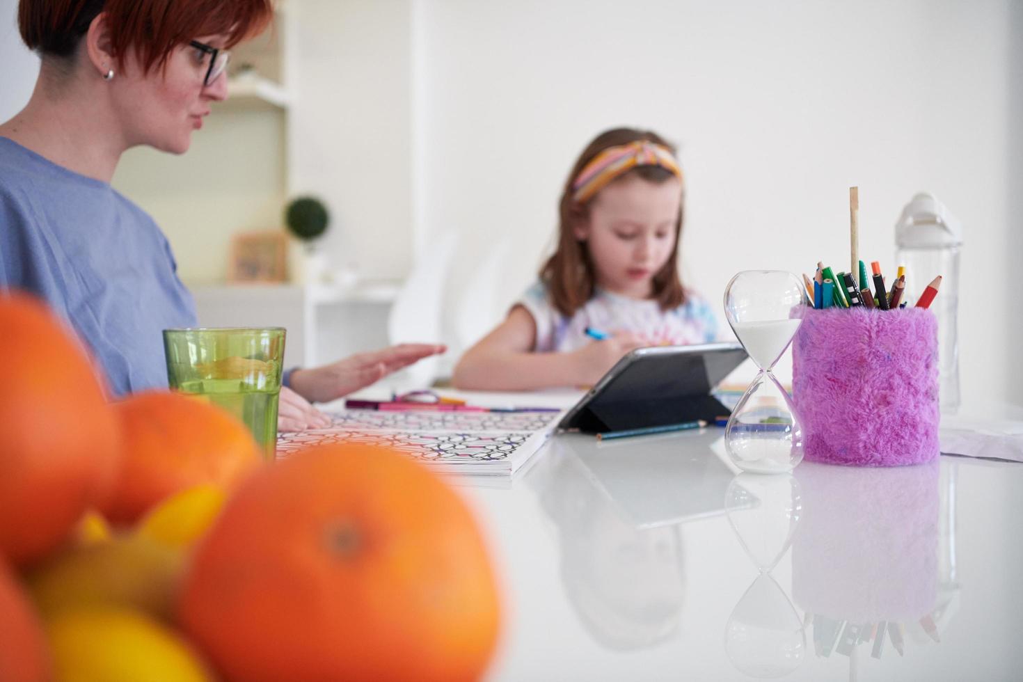 Mother and little daughter  playing together  drawing creative artwork photo