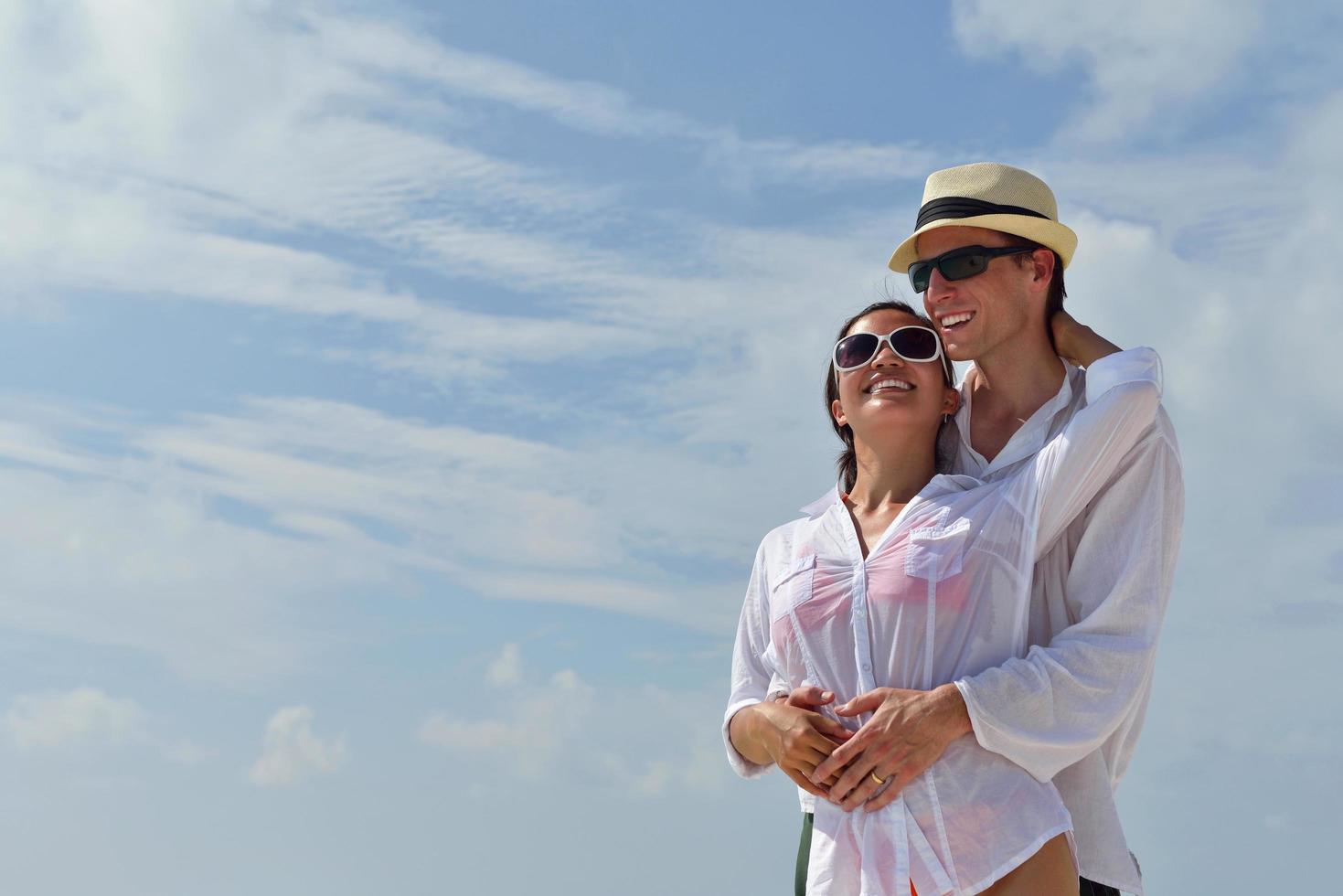 happy young couple have fun on beach photo