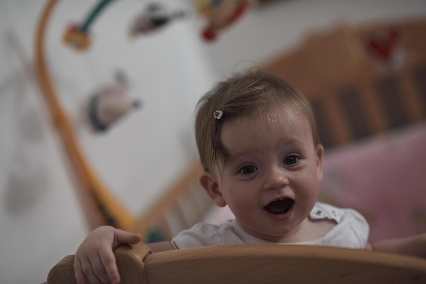 cute  little one year old baby and making first steps in bed photo