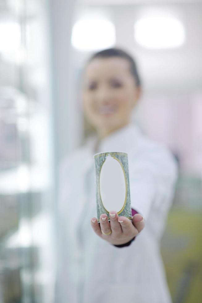 pharmacist chemist woman standing in pharmacy drugstore photo