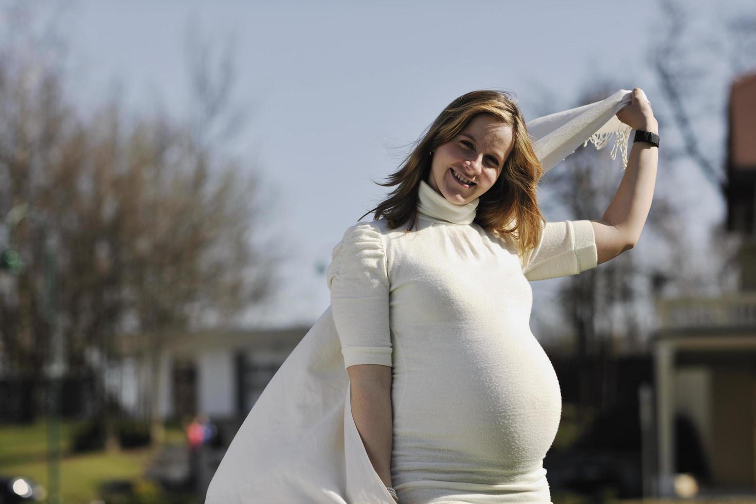 happy young pregnant woman outdoor photo