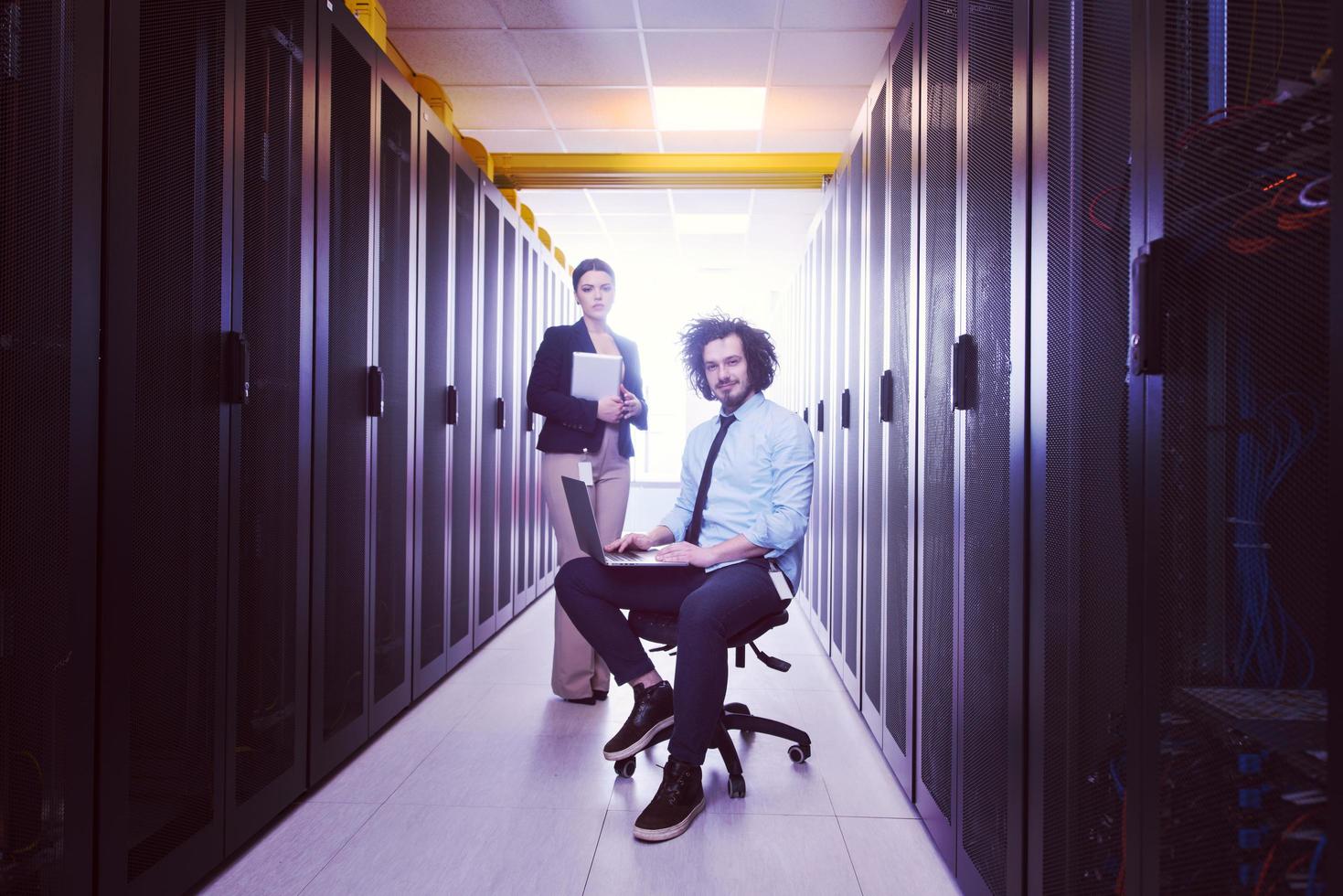 Team of young technicians working together on servers photo