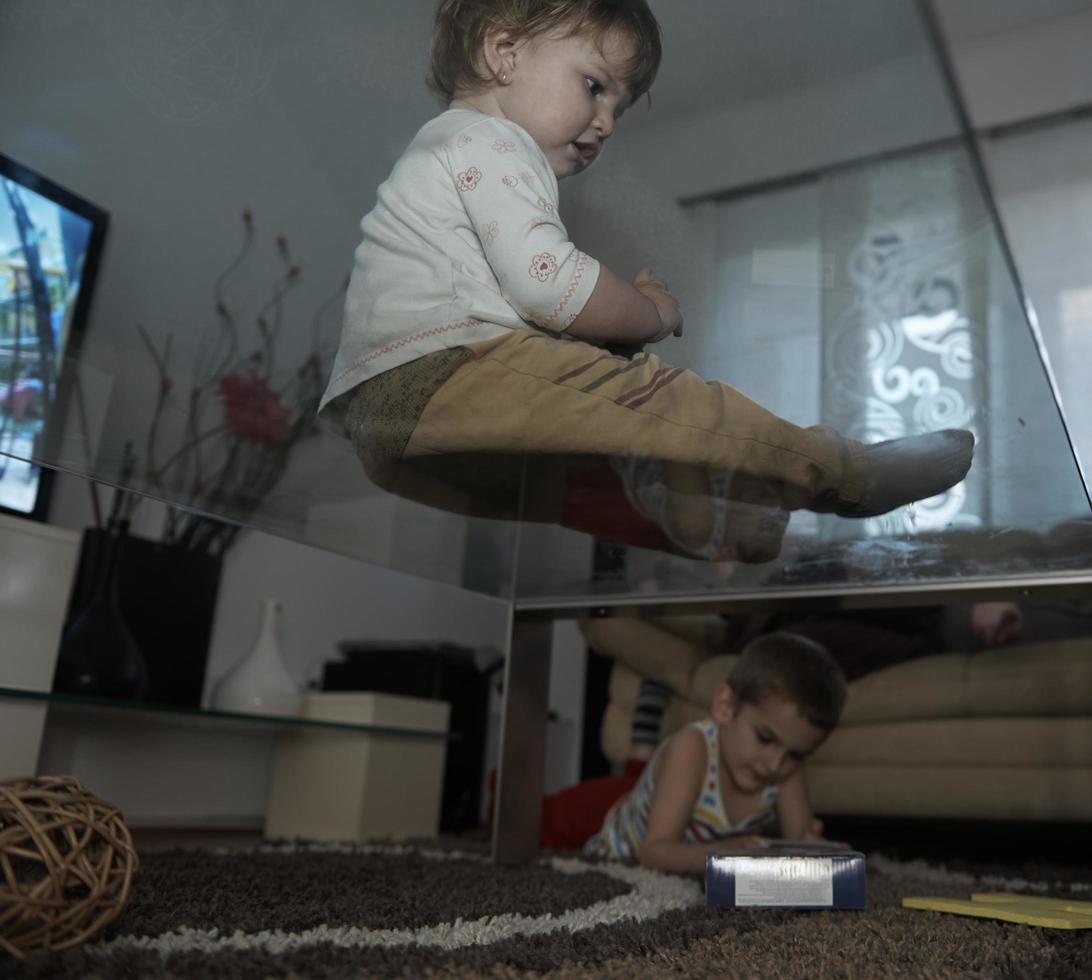 Little child playing  with sister at home photo