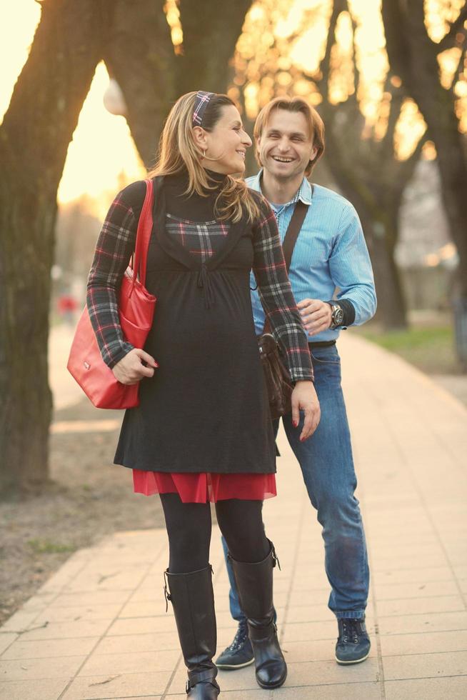 young pregnant couple have fun and relax photo