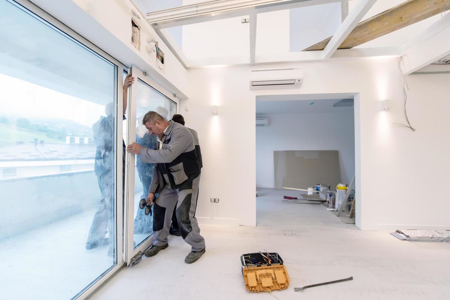 carpenters installing a balcony door photo
