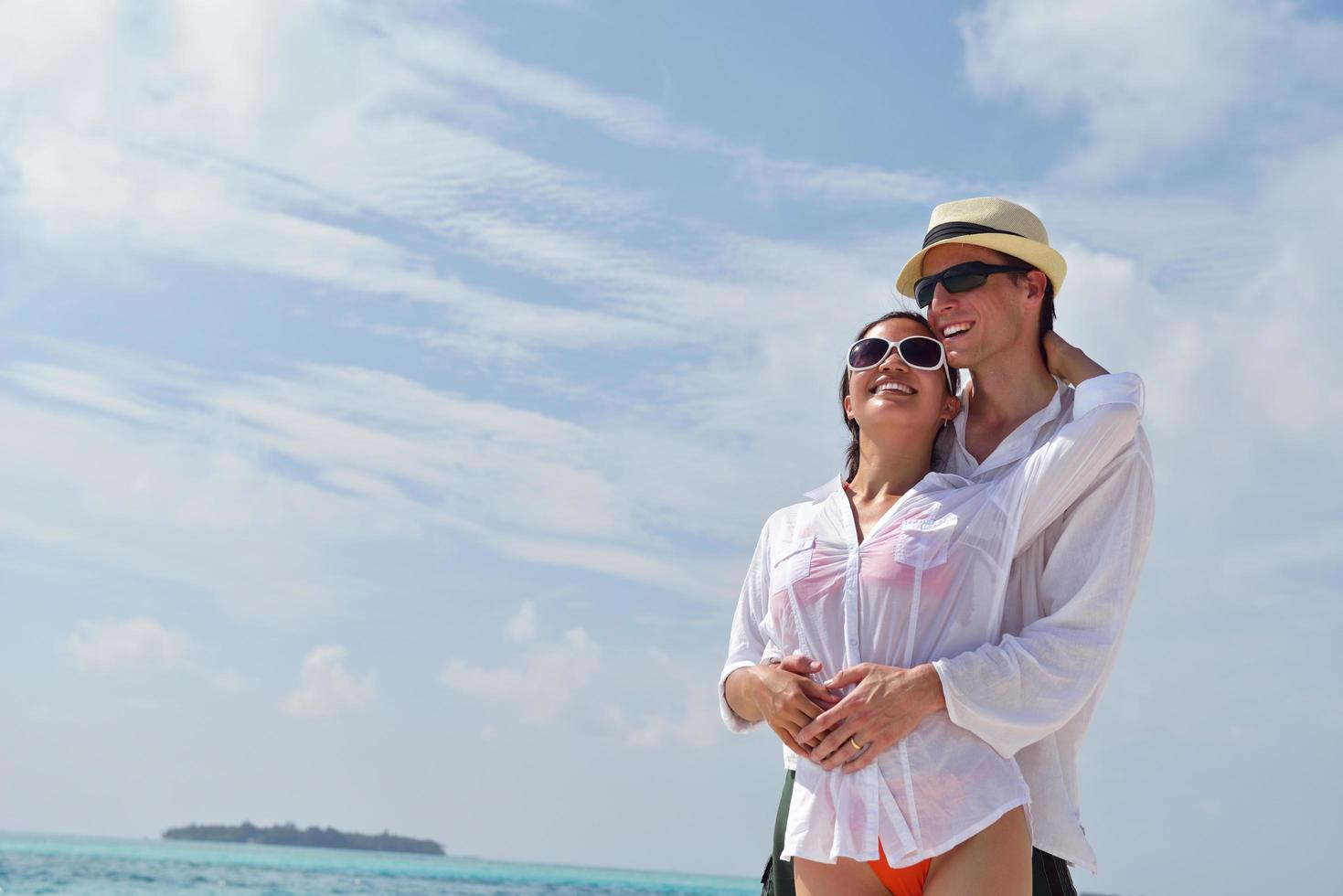 happy young couple have fun on beach photo