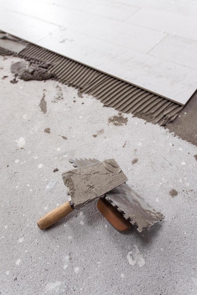 Ceramic wood effect tiles and tools for tiler on the floor photo