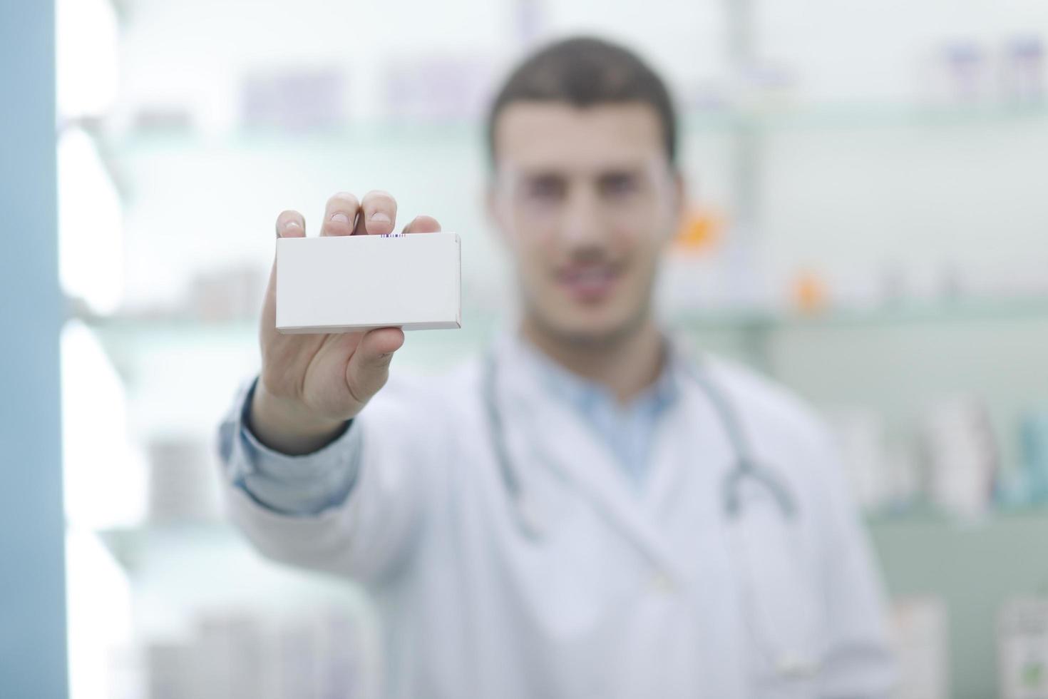 pharmacist chemist man in pharmacy drugstore photo