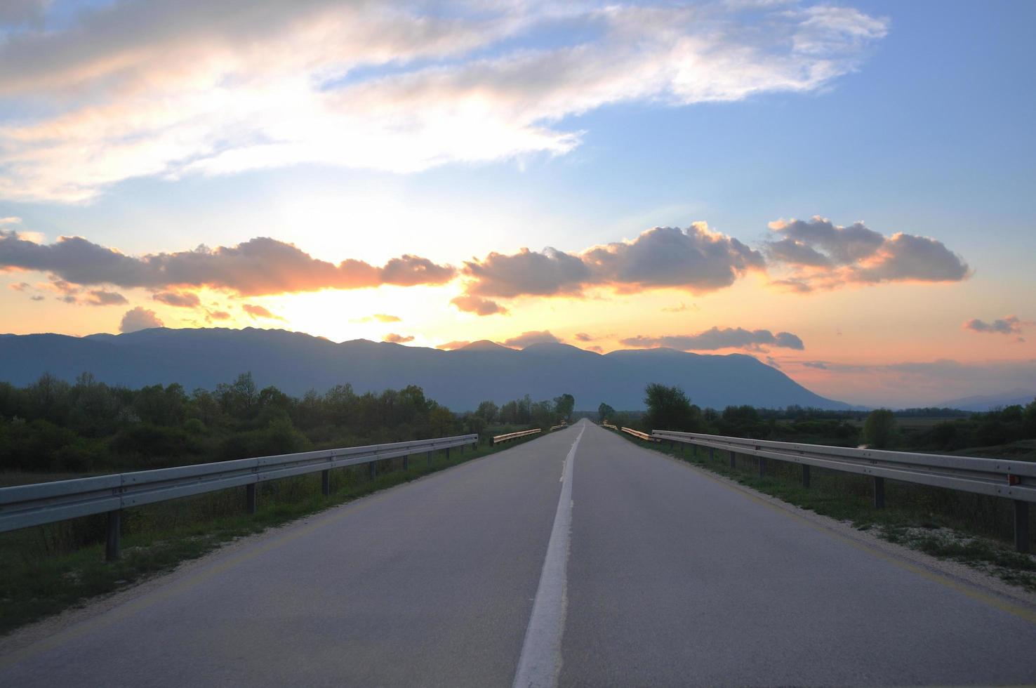 countryroad adventure with beautiful sunset photo