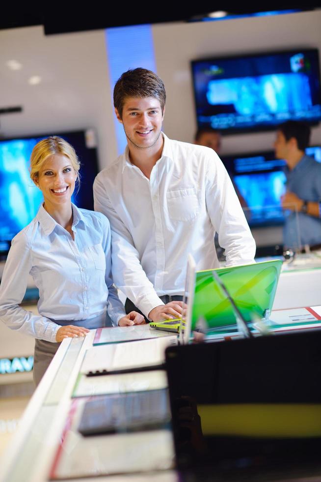 People in electronics store photo