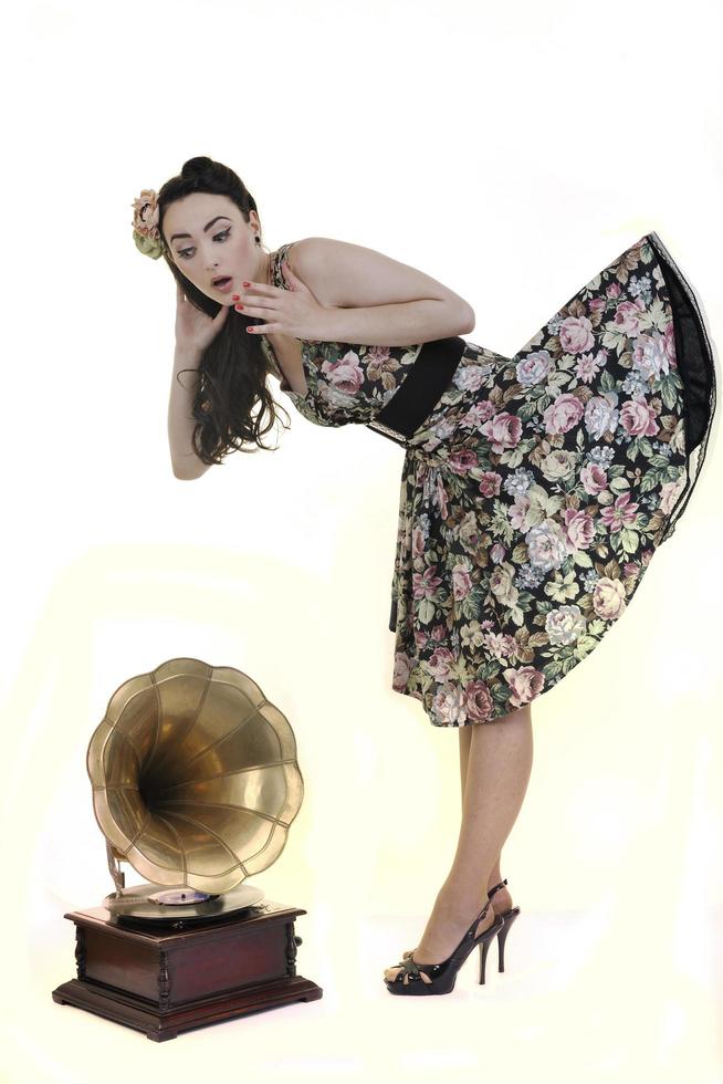 pretty girl listening music on old gramophone photo