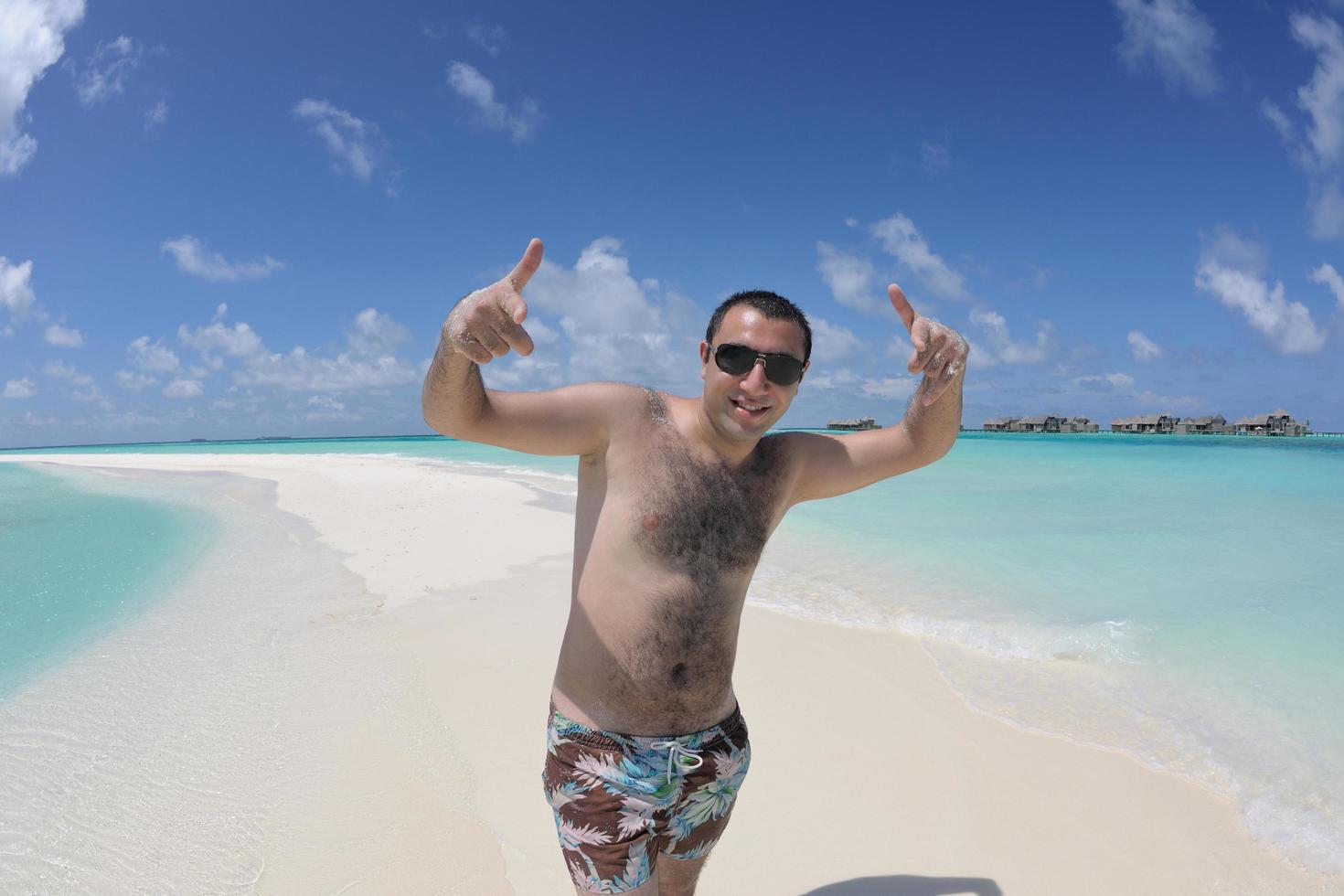 young man have fun and relax on beach photo