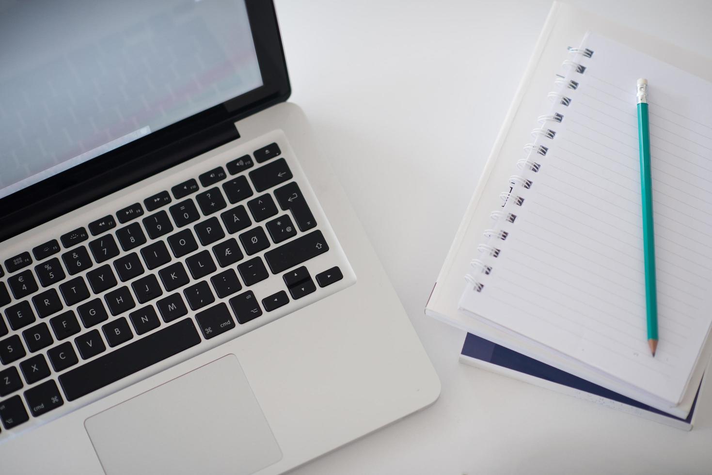 flat lay of laptop and notepad photo