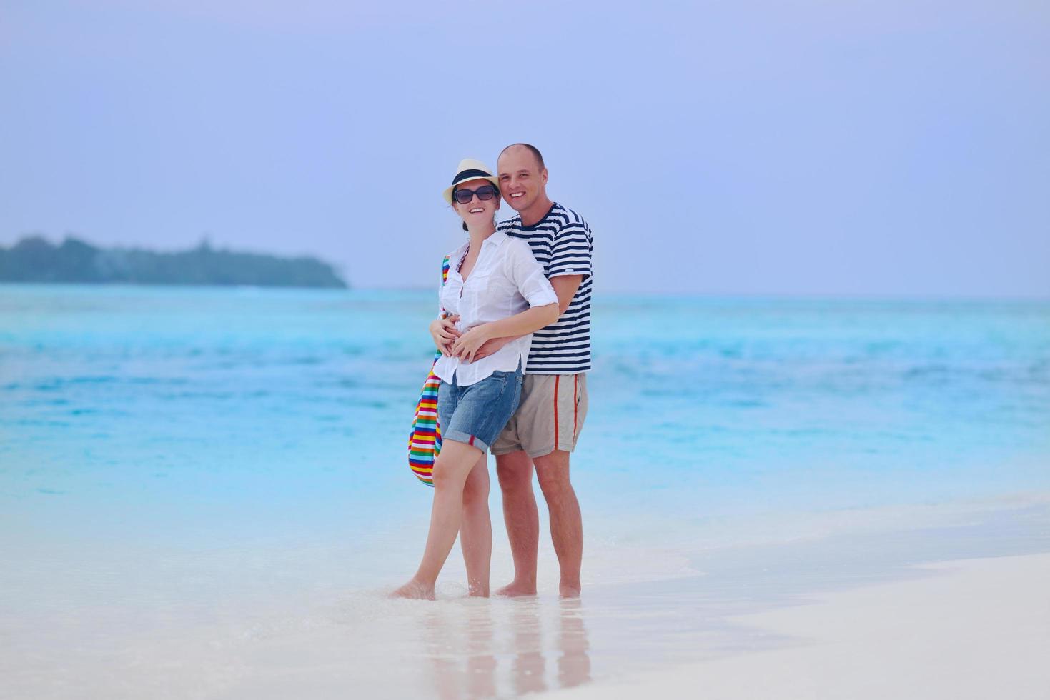 happy young couple have fun on beach photo