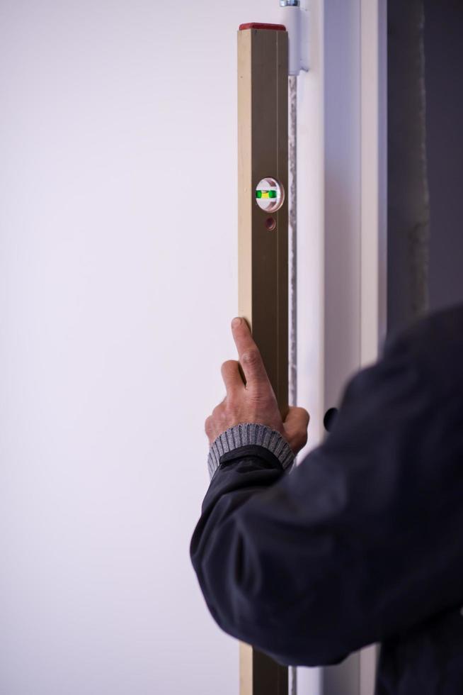 carpenter using level tool photo