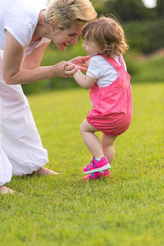 mother and little daughter playing at backyard photo