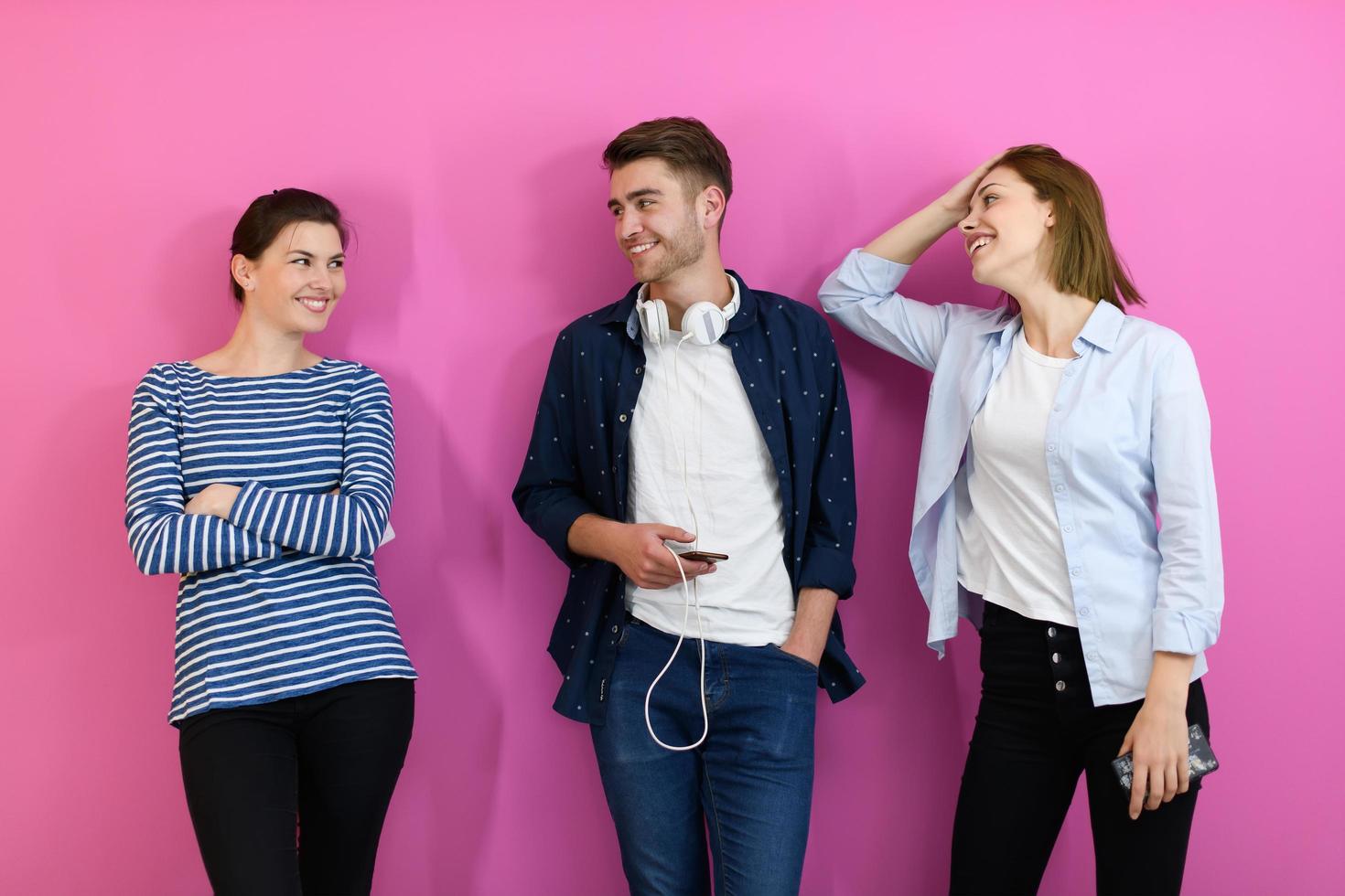 group of friends have fun and dance while using a cell phone and headphones photo