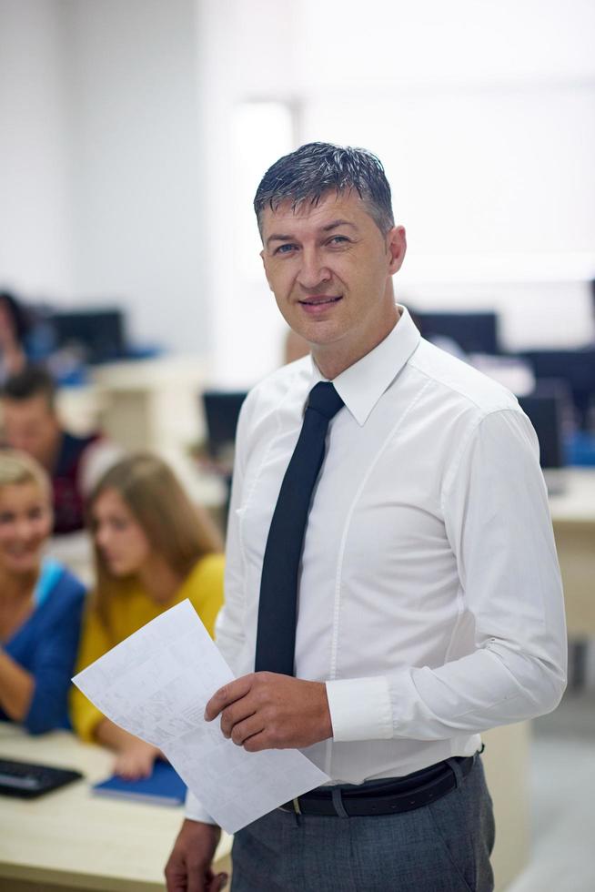 students with teacher  in computer lab classrom photo