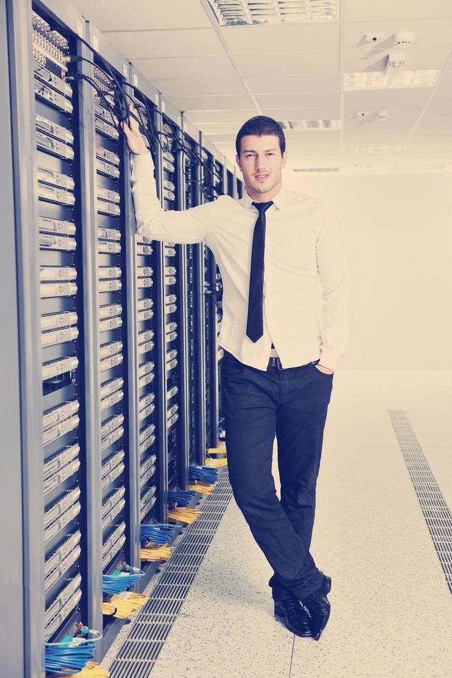 young engeneer in datacenter server room photo