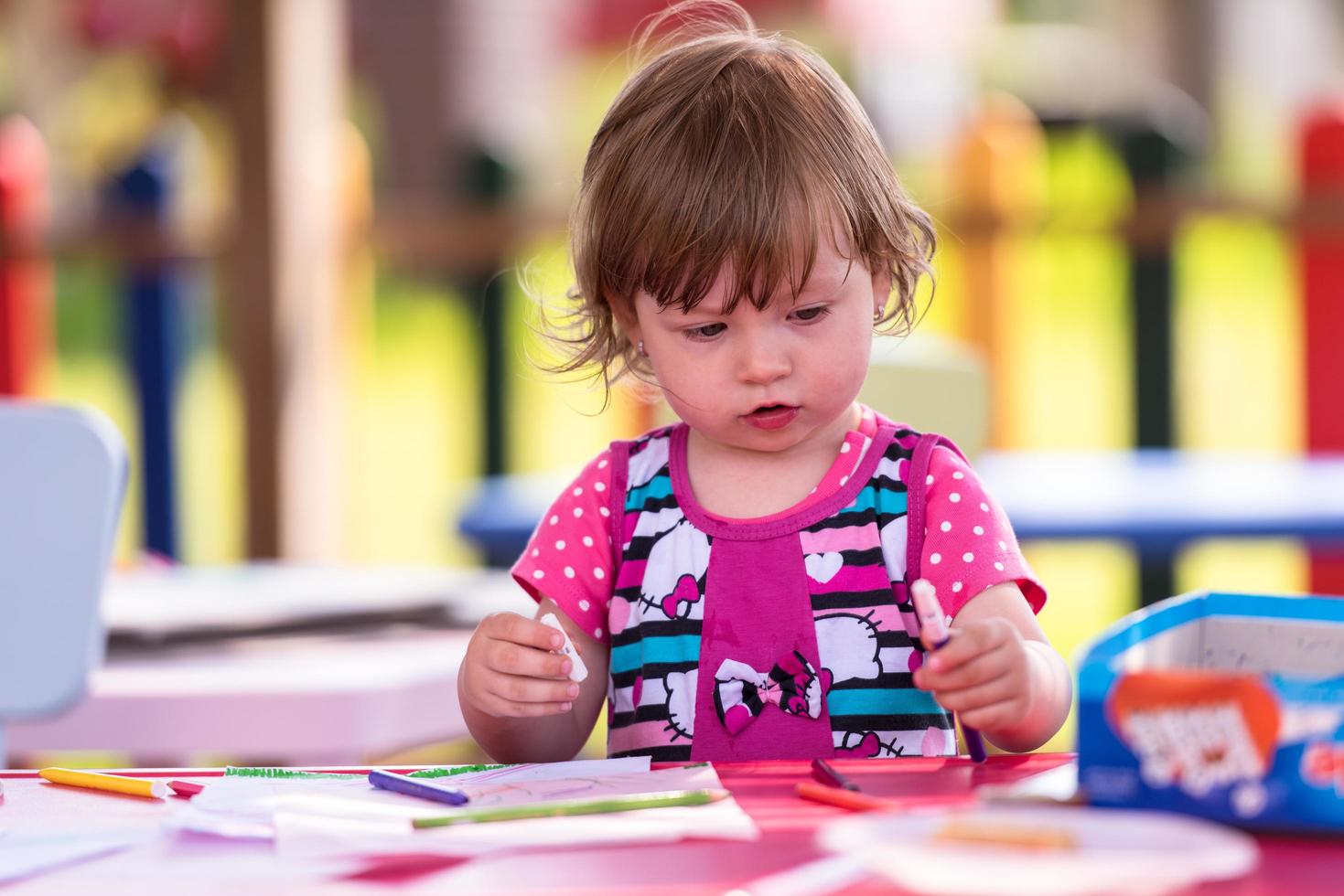 little girl drawing a colorful pictures photo