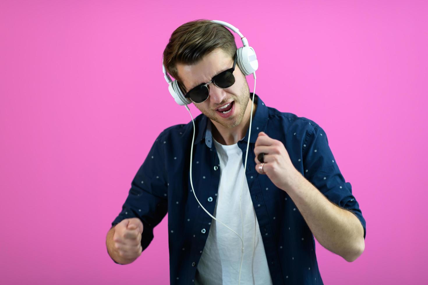 guy wears glasses and headphones while dancing and having fun photo