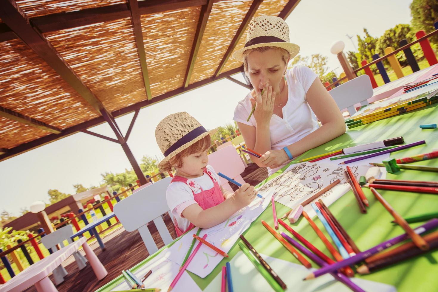 mom and little daughter drawing a colorful pictures photo