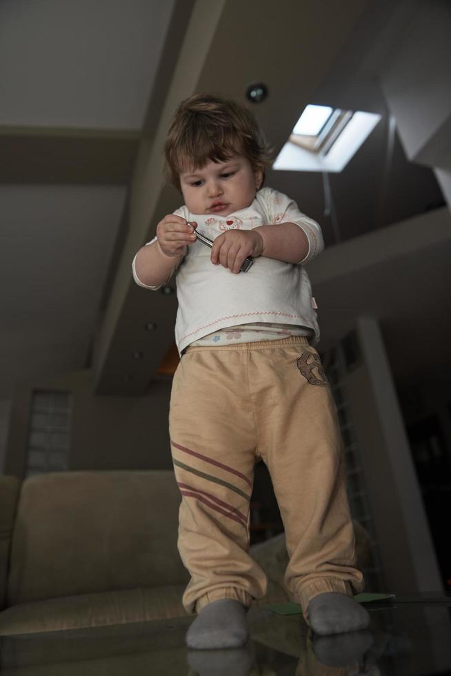 Adorable cute beautiful little baby girl playing with toys at home photo