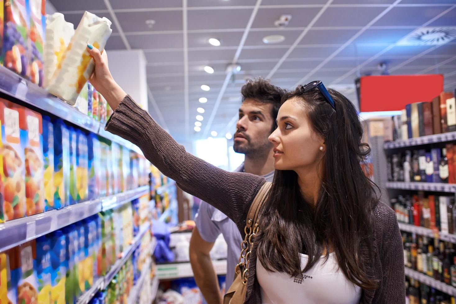 couple shopping in a supermarket photo