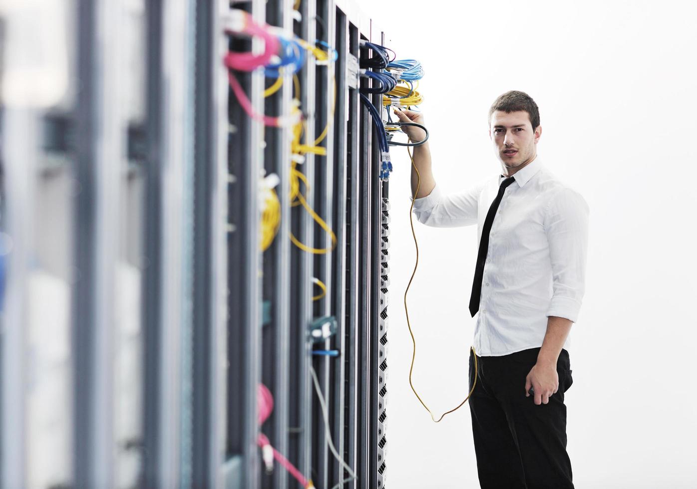young it engeneer in datacenter server room photo