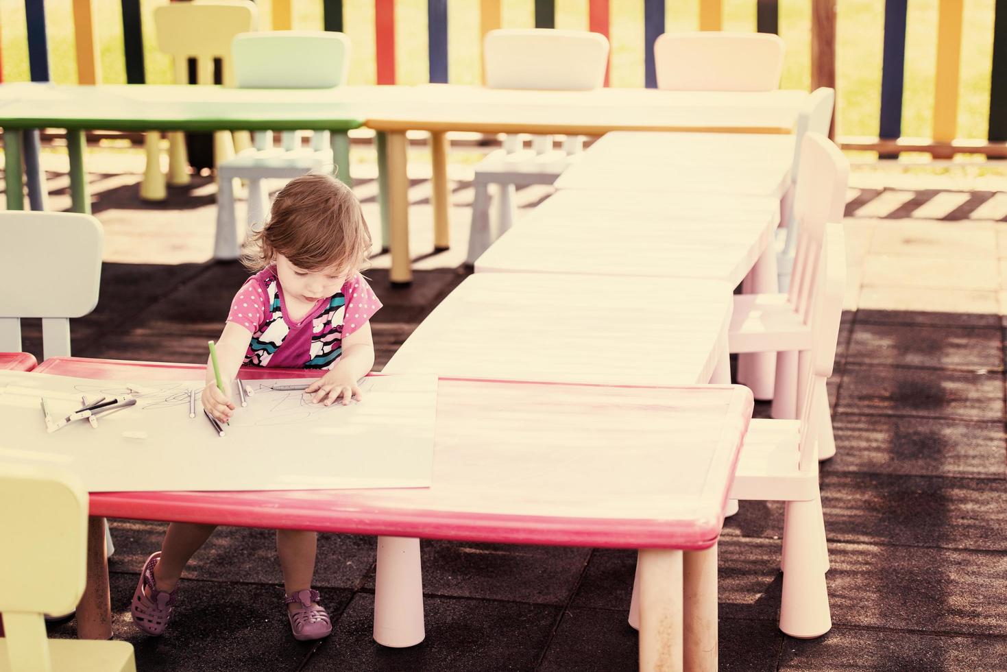 little girl drawing a colorful pictures photo