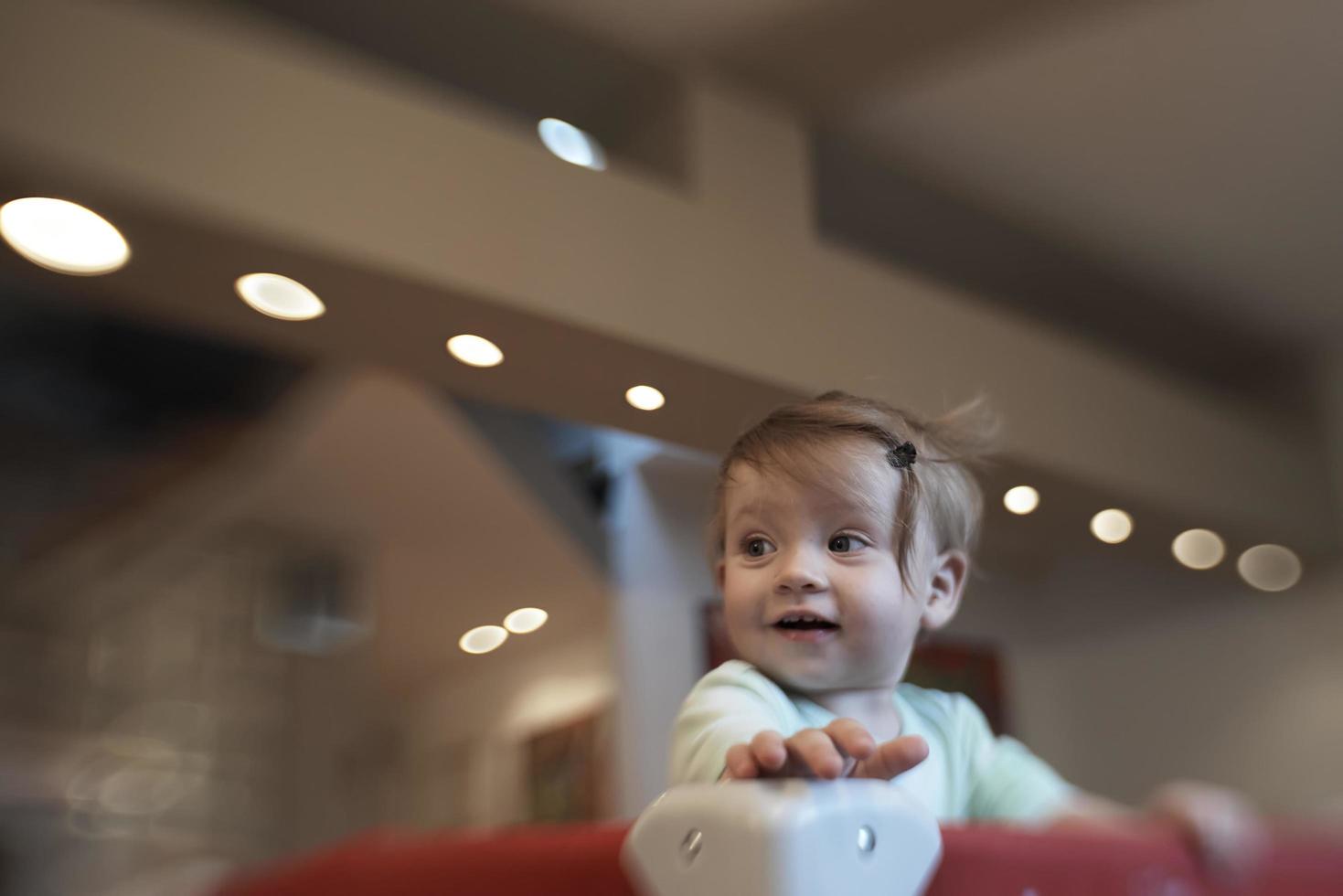 cute  little  baby playing in mobile  bed photo