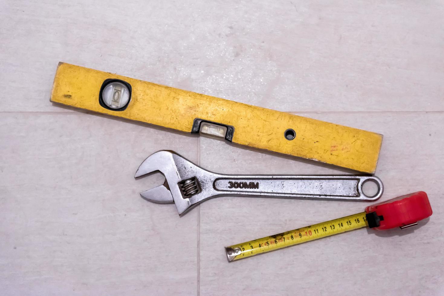 set of hand working tools on ceramic tile background photo